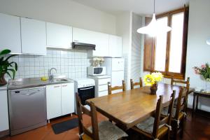 a kitchen and dining room with a wooden table at VILLA IL SORRISO in Bivigliano
