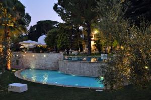 a swimming pool in a yard at night at Villa delle Querce Resort in Palo del Colle