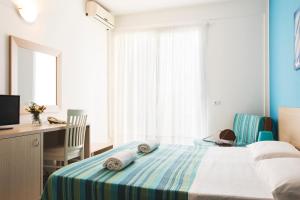 Postel nebo postele na pokoji v ubytování Hotel Baia Del Sole