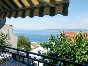 a view of the ocean from the balcony of a house at villa NIKOLA in Brela
