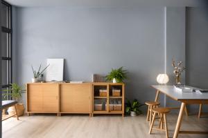 a wooden cabinet in a room with a table at MR. NORDIC INN in Hualien City