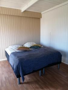 a bed with two pillows on it in a room at Djurviks Gästgård in Gottby
