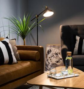 a living room with a table with a bottle on it at MR. NORDIC INN in Hualien City
