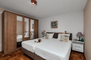 a bedroom with a large bed with white sheets at Villa Ana in Podgora +38 photos
