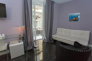a living room with a couch and a window at Chiaia 205 in Naples