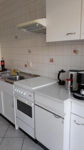 a kitchen with white appliances and a white counter top at 5 Gartenstraße in Angermünde