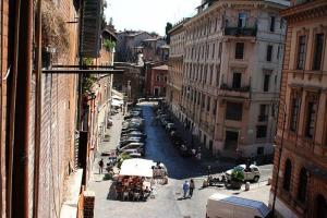 a view of a canal in a city with cars at Portico d'Ottavia, the ancient Rome in Rome