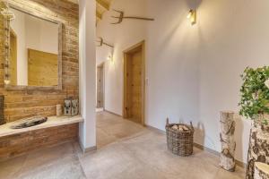 a hallway with a brick wall and a mirror at Pension und Ferienchalets Zum Lebzelter in Freyung +21 photos