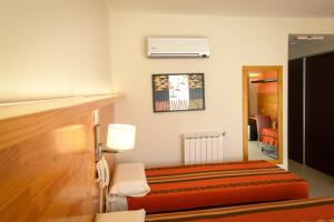 ein Hotelzimmer mit einem Bett und einem Spiegel in der Unterkunft Amérian Villa del Dique in Villa del Dique