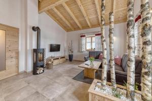 a living room with a couch and a wood stove at Pension und Ferienchalets Zum Lebzelter in Freyung