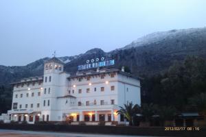 a large white building with a sign on top of it at La Sierra in Antequera +26 photos