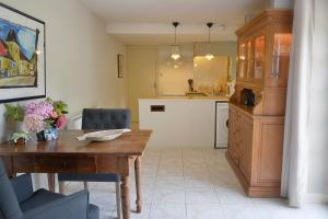 a kitchen with a wooden table and a dining room at Le Prieuré Le Pavillon in Souillac +10 photos