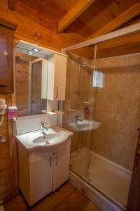 a bathroom with a sink and a shower at Sea Valley Lodge in Faralya