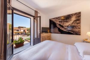 a bedroom with a bed and a large window at Locanda Tartarughino - Luxury Suites in Porto Rotondo in Porto Rotondo
