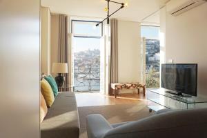 a living room filled with furniture and a tv at Porto View by Patio 25 in Vila Nova de Gaia