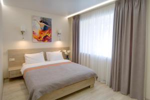 a bedroom with a large bed and a window at Arena Summit Apart Hotel in Kyiv