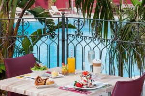 a table with food and a candle on it at Leonardo Privilege Eilat Hotel - All inclusive in Eilat