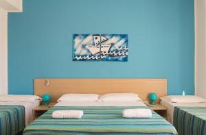 Postel nebo postele na pokoji v ubytování Hotel Baia Del Sole