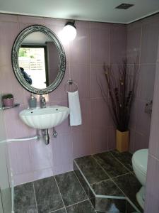 a bathroom with a sink and a mirror at country & sea in Artemida