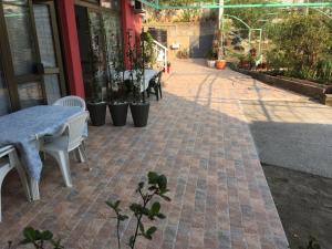 a patio with a table and chairs on a brick sidewalk at Studio Max in Bijela