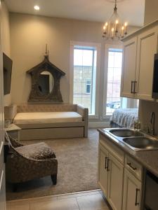 a kitchen with a bed and a sink in a room at Inn On Central in Le Mars