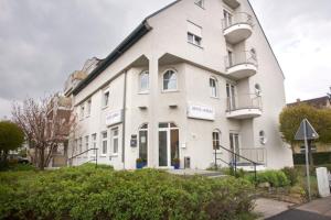 a large white building with balconies on it at Hotel Mörike in Ludwigsburg