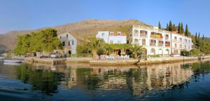 a group of buildings next to a body of water at Villa Kukuljica in Zaton