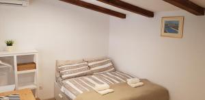 a bedroom with a bed with towels on it at Country house in Ankaran