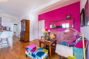 a living room with a pink wall at Maja Apartment Cavtat II in Cavtat