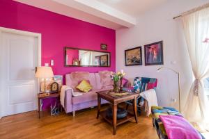 a living room with a purple wall at Maja Apartment Cavtat II in Cavtat