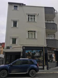 a blue suv parked in front of a building at GÖKTÜRK APART in Trabzon