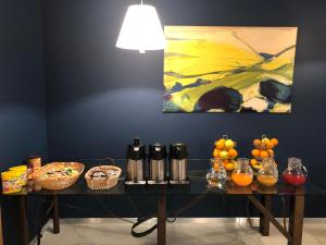 a table with a painting on the wall with fruit on it at Villa Regina in Riva del Garda