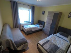 Postel nebo postele na pokoji v ubytování Apartamenty pod Dzikowcem + 37 fotografií
