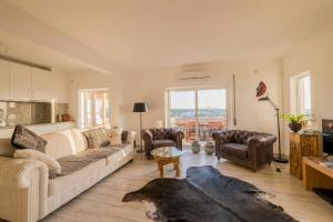 a living room with a couch and a table at Tavira Apartment in Tavira