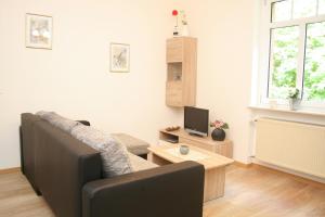 a living room with a couch and a television at Wald Villa Üssbach in Alf