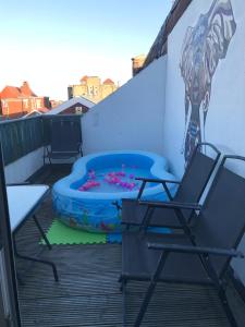 a patio with a trampoline and two chairs on a balcony at Blackpool Home with Tower View in Blackpool