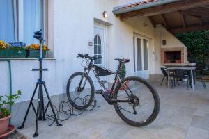 a bike is parked in front of a house at Apartment Green Garden in Pula