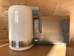 a toaster sitting on a counter next to a microwave at Sutor Coops The Den with Hot Tub in Cromarty