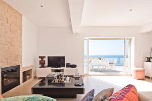 een woonkamer met open haard en een tafel bij Cubo in Sintra