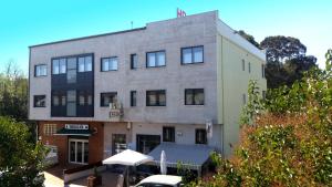 a building with a car parked in front of it at Peregrino in Pontevedra