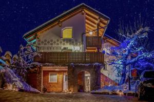 a house in the snow at night at Apartments Koledniki in Bled