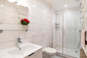 a white bathroom with a toilet and a sink at CityCosy Strasbourg - T2 Hirtz Orangerie in Strasbourg