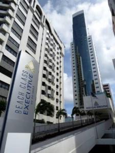 a sign in front of two tall buildings at Flat Executive Beira Mar in Recife