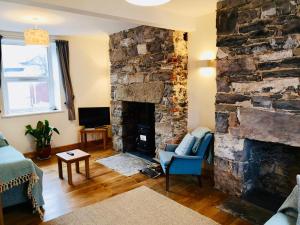 a living room with a large stone fireplace at Pen-y-Patch in Prestatyn