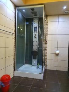 a shower with a glass door in a bathroom at Apartman Marković in Bosanski Šamac
