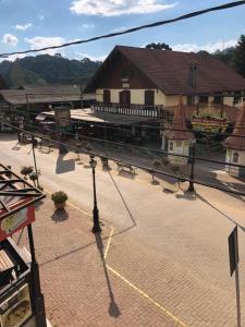 a large building with a train station in the background at Apartamento Girassol love in Monte Verde