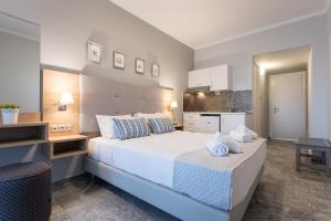 A bed or beds in a room at Georgioupolis Beach Hotel