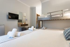 A bed or beds in a room at Georgioupolis Beach Hotel