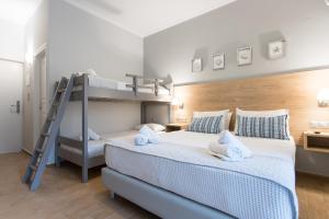 A bed or beds in a room at Georgioupolis Beach Hotel