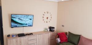 a living room with a flat screen tv on a wall at Casa Saphia de Melilla in Melilla